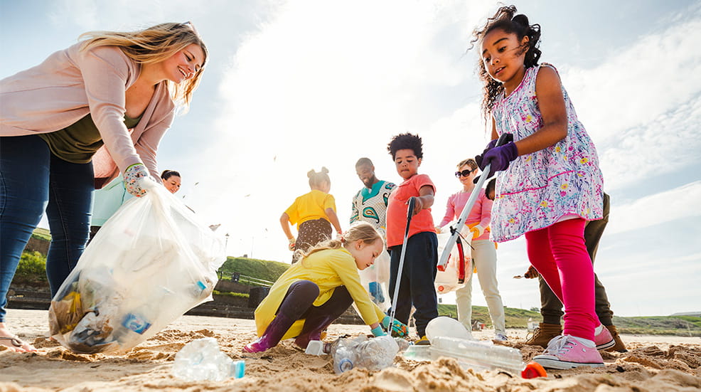 Group of local people all coming together to clean up their local beach